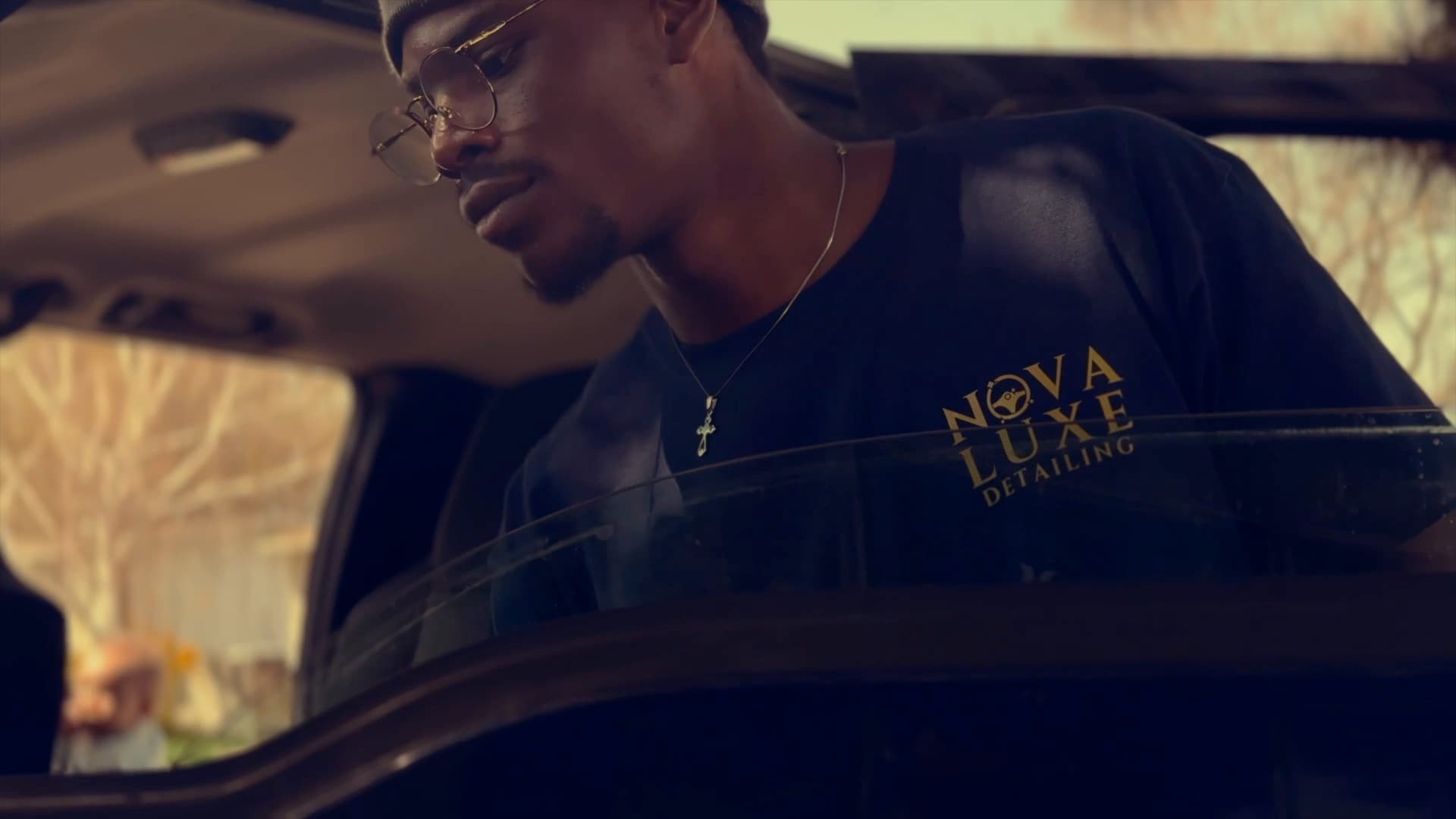 A Nova Luxe detailer working on a vehicle at golden hour