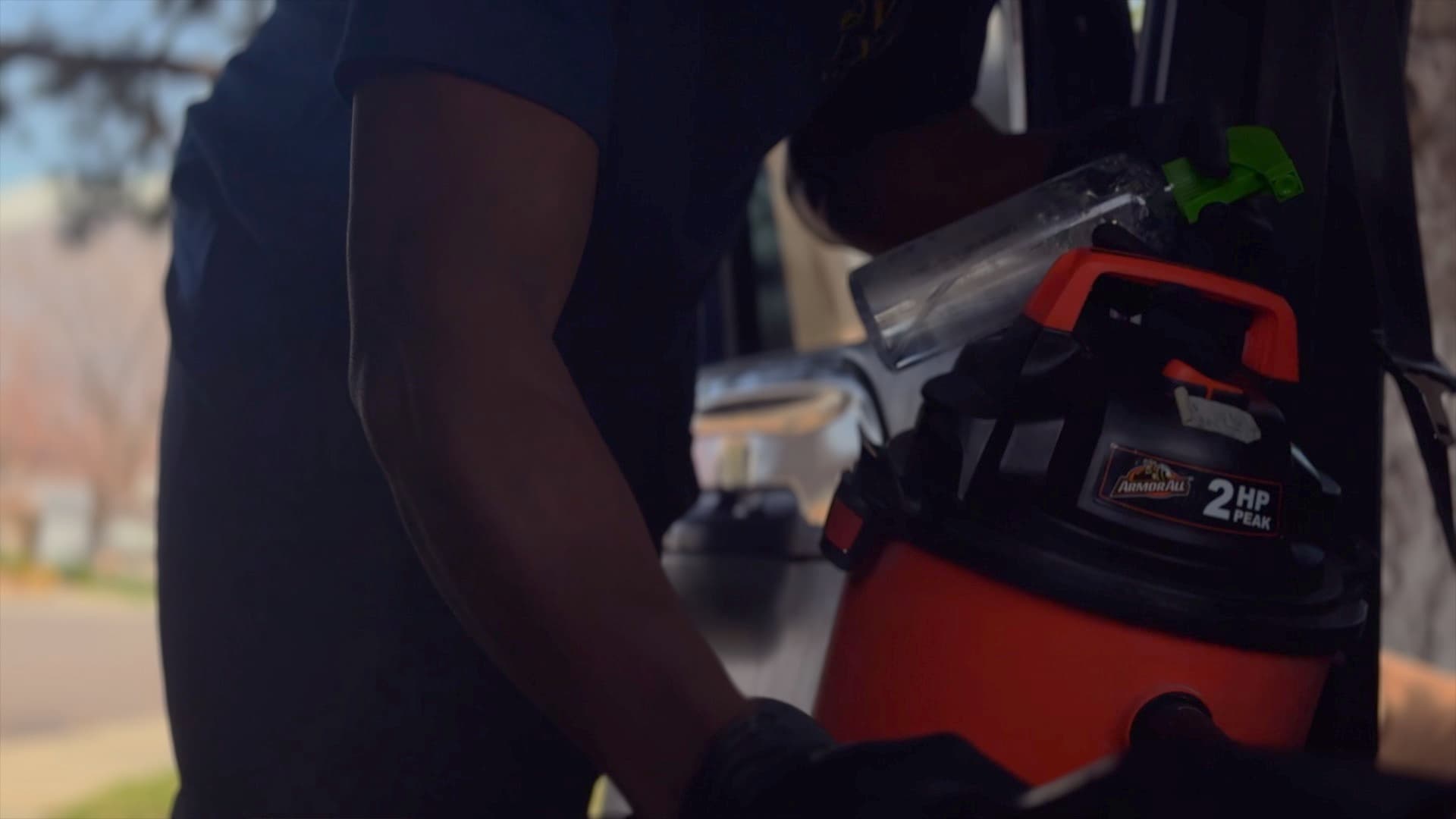 A Nova Luxe detailer reaching into an open car door