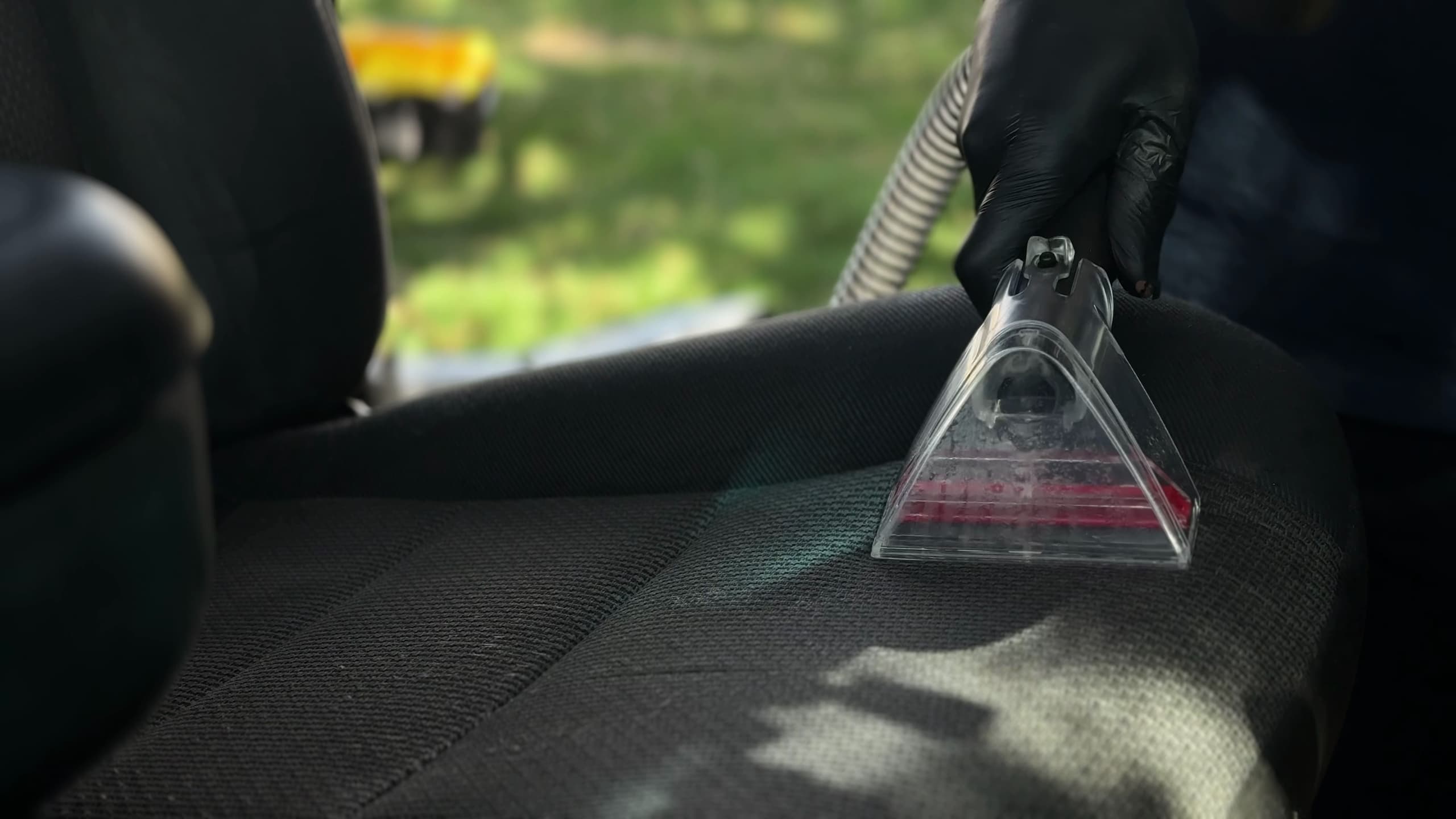 Interior door card being wiped down with a microfiber cloth